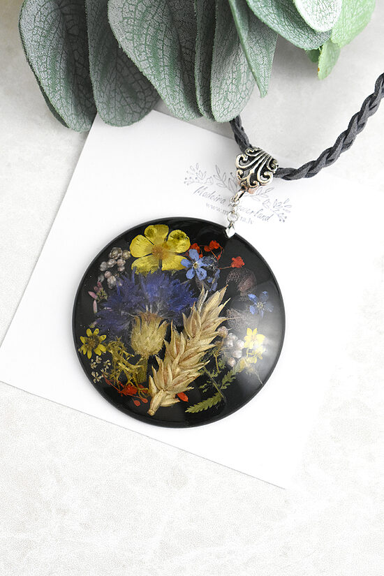 Pendant with natural Latvian flowers