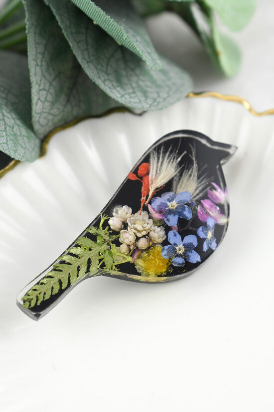 Colorful brooch with a bird