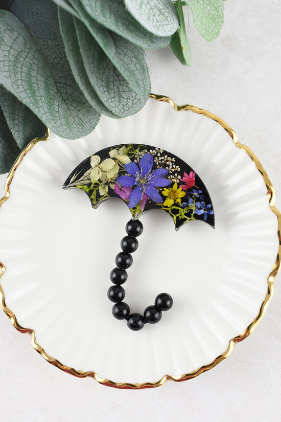 Piespraude Lietussargs ar ziediem