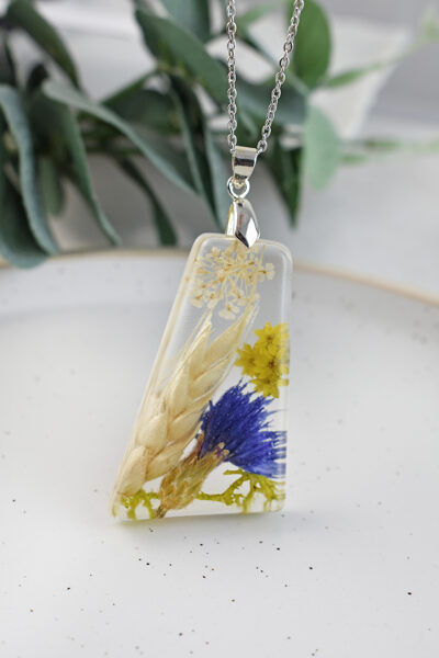 Caurspīdīgs kulons ar rudzupuķi un vārpu 